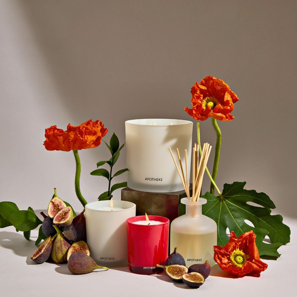 Apotheke candles and diffusers with flowers and figs on a neutral background