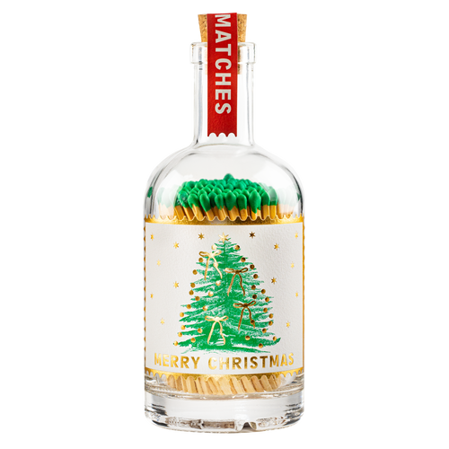 An Archivist Christmas-themed glass match bottle. The clear glass bottle is filled with green match heads and gold match tips, featuring a white paper label with a gold glittery Christmas tree and the text 'MERRY CHRISTMAS' and 'MATCHES' on a red neck tag.