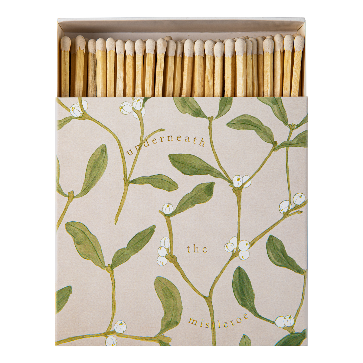 An Archivist square matchbox package of wooden matches with a beige cover printed with green mistletoe branches, white berries, and the words 'underneath the mistletoe.' The matches are arranged upright inside an open box against a plain white background.