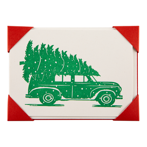 An Archivist square Holiday card set, featuring a green vintage station wagon carrying a Christmas tree on a white background, with red corner accents.