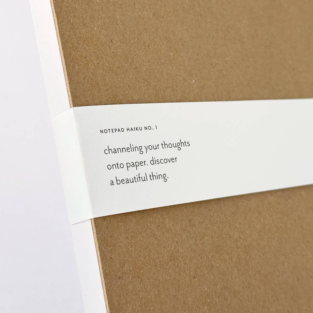 Brown Felix Doolittle notepad back with a white label featuring text on a white background
