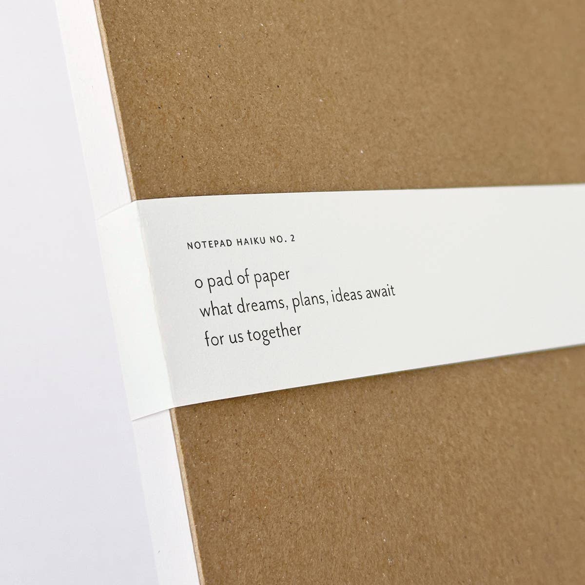 Close-up of a Felix Doolittle notepad back with a haiku on the paper