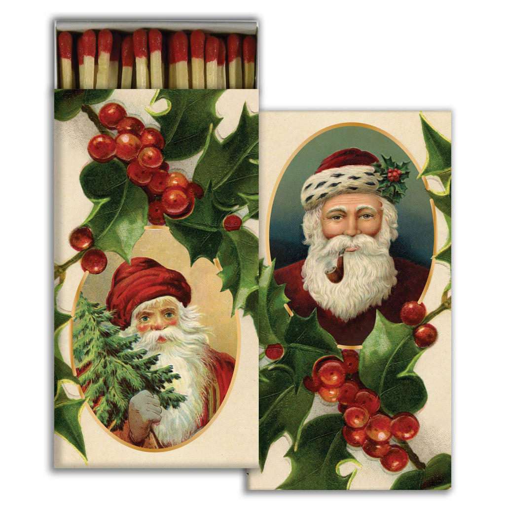 Matchbox with vintage-style illustration of Santa Claus and holly leaves on a white background