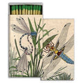 Matchbox with illustrations of dragonflies and grass on a beige background