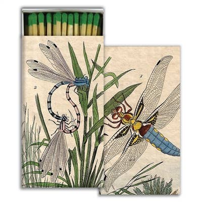 Matchbox with illustrations of dragonflies and grass on a beige background