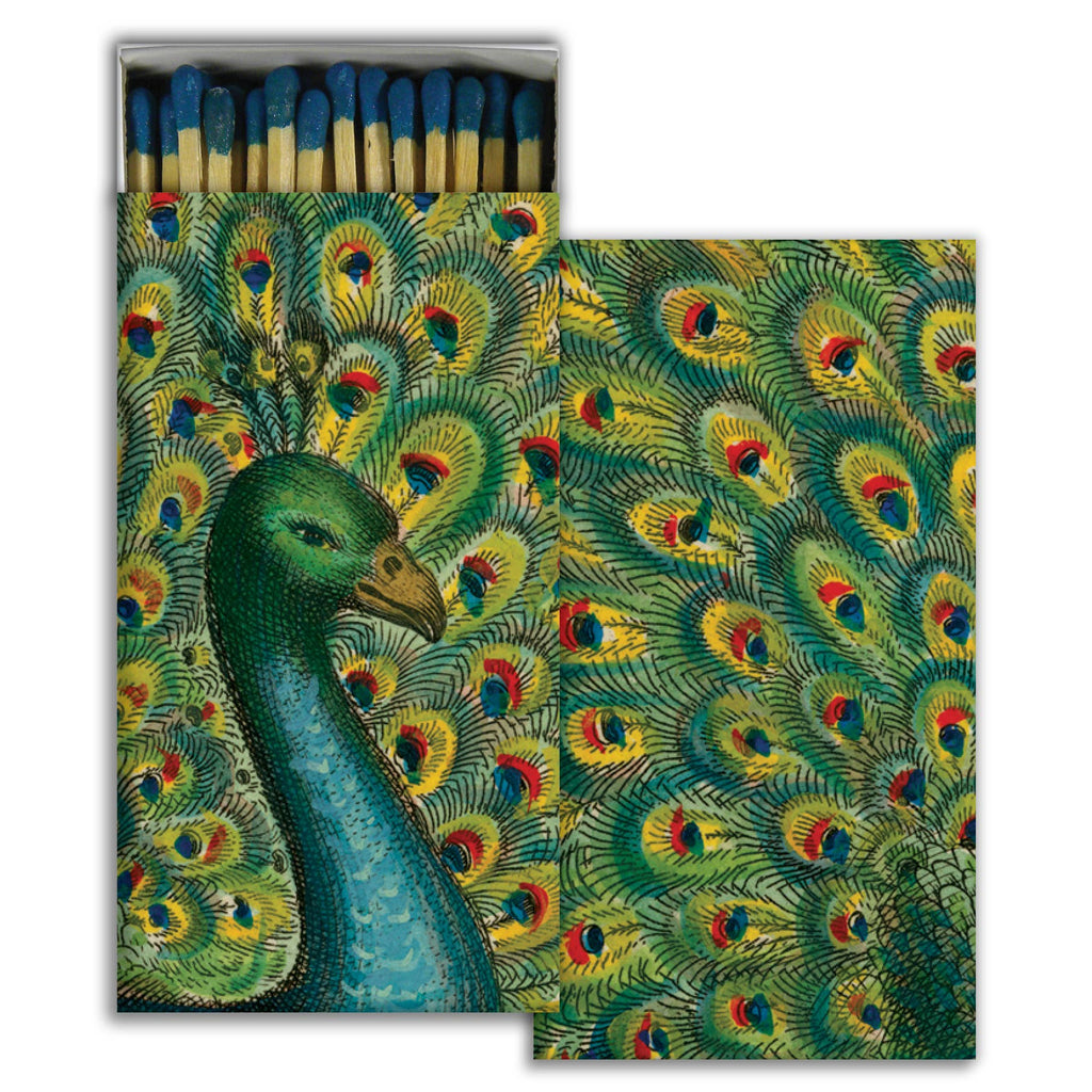 Matchbox with peacock design on a white background