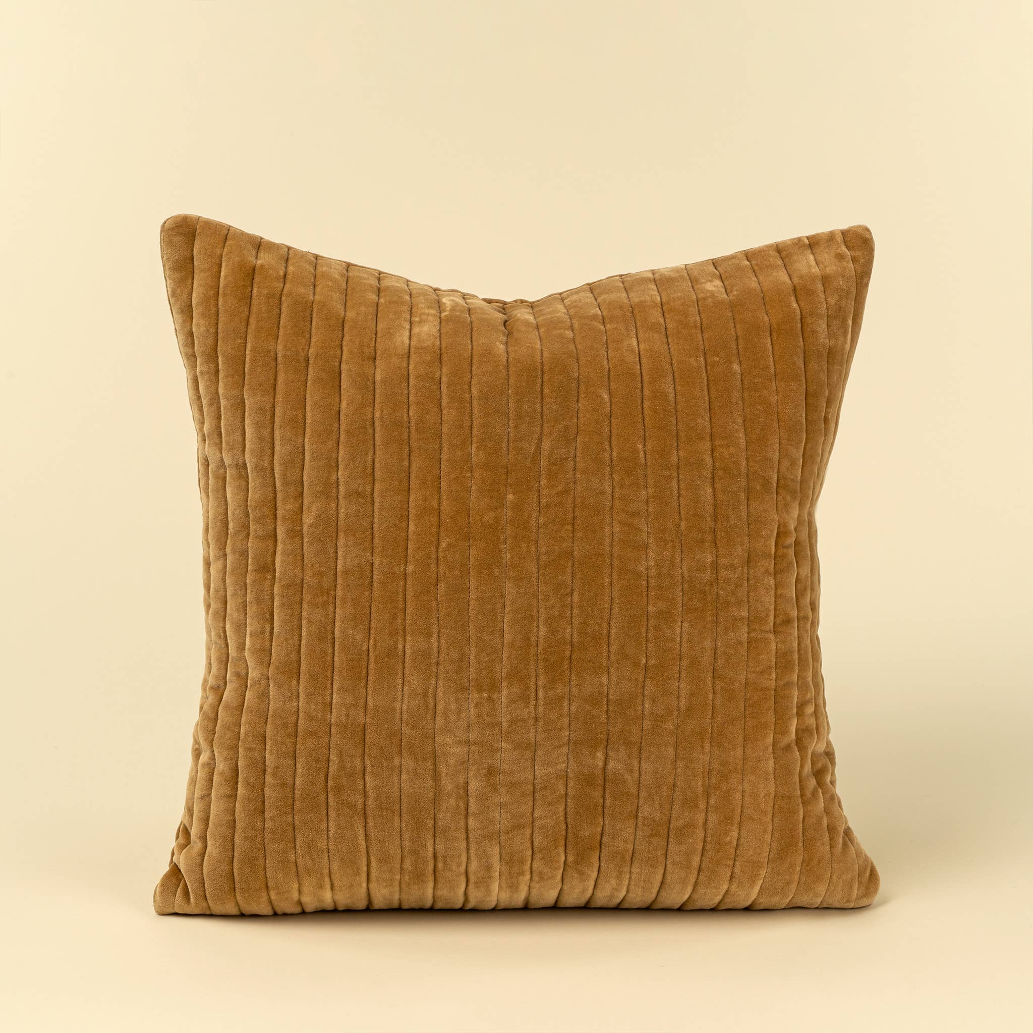 A square throw pillow in a warm camel brown corduroy fabric, shown against a solid cream background.