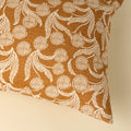 Fabric swatch with a floral pattern on a brown background