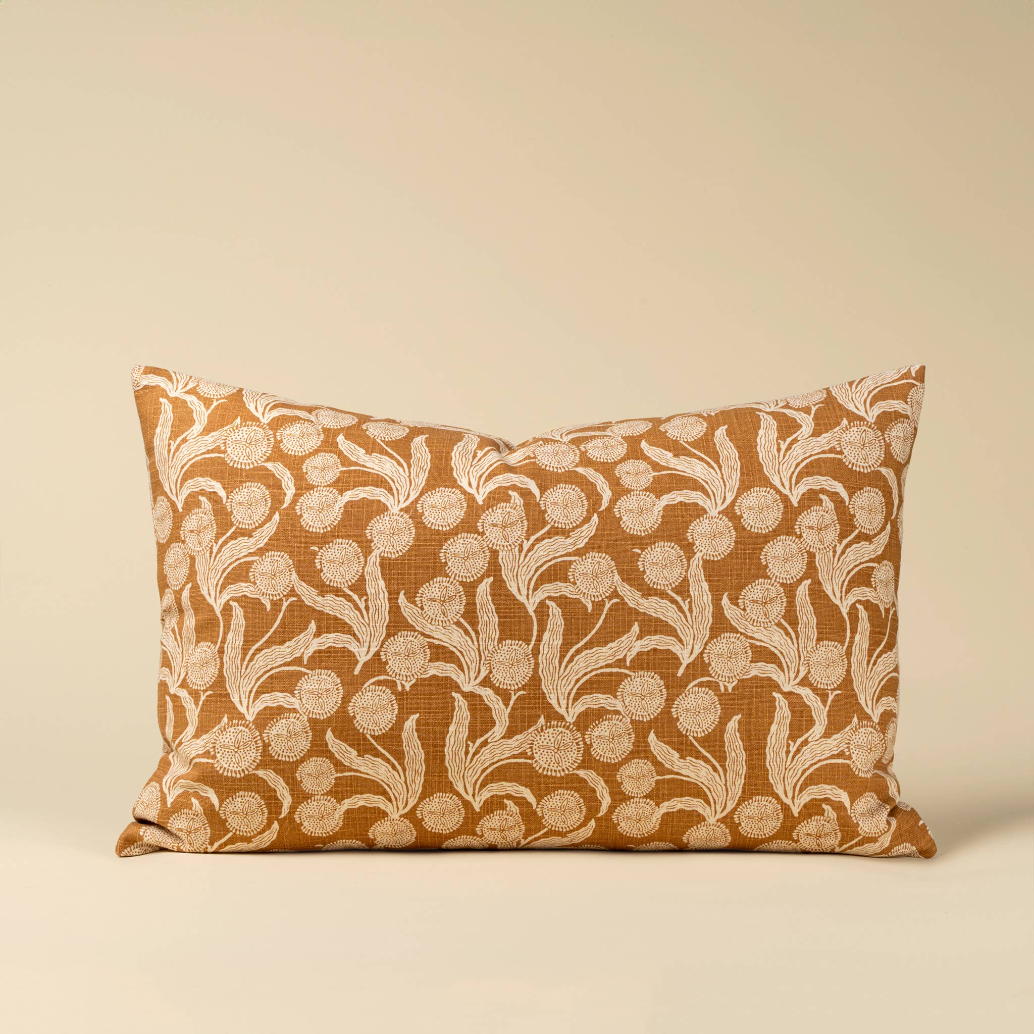 Decorative pillow with floral pattern on a beige background
