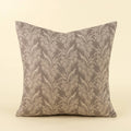 A square throw pillow featuring a classic damask floral pattern in taupe and beige, set against a solid cream background.