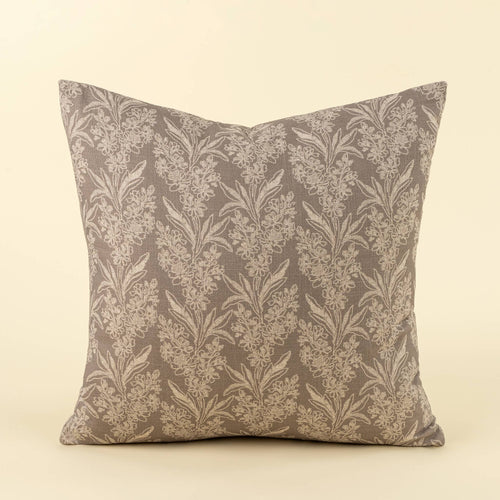 A square throw pillow featuring a classic damask floral pattern in taupe and beige, set against a solid cream background.