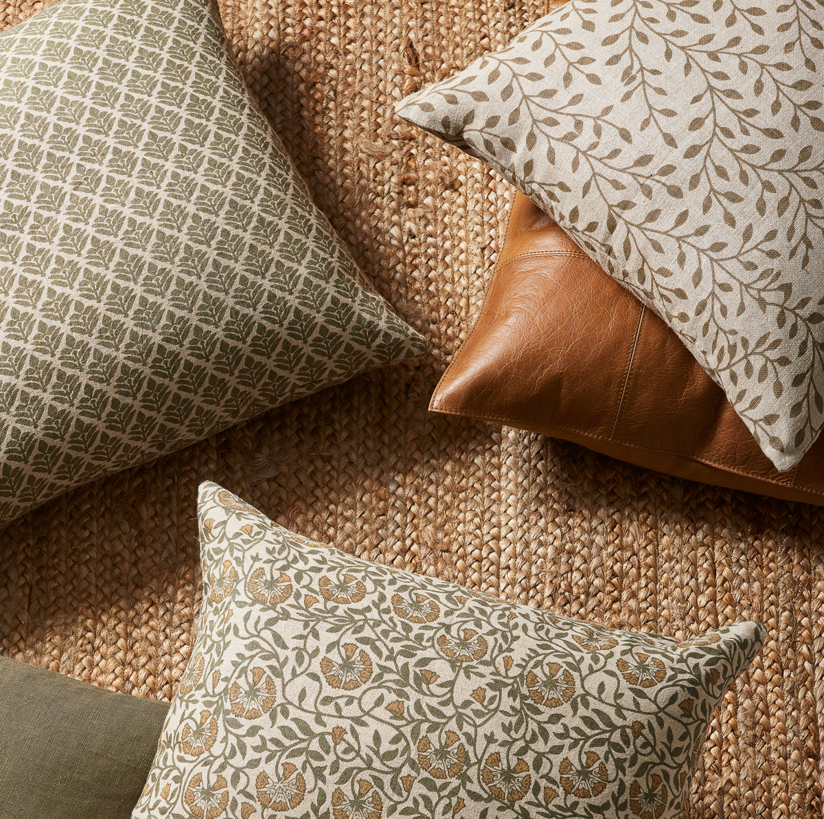 Patterned Liam and Lana linen pillows with down fill on a textured surface