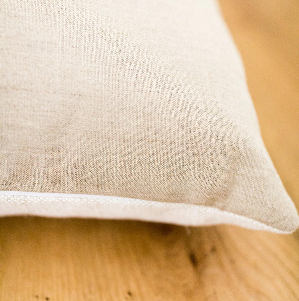 Close-up of a natural linen fabric pillow back on a wooden surface