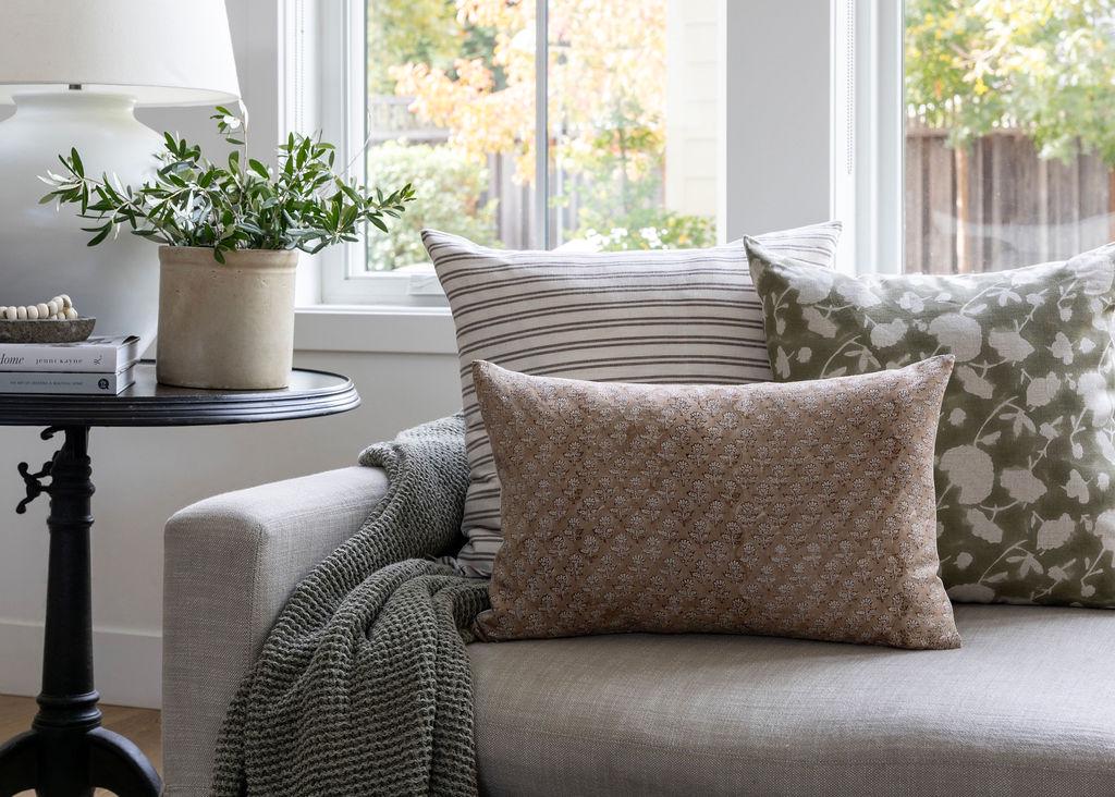 Gray sofa with patterned Linen & Cloth throw pillows in a bright living room
