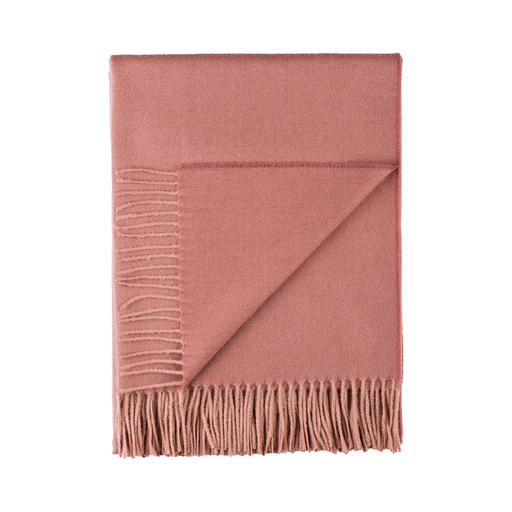 Pink Alpaca throw blanket with fringes on a white background