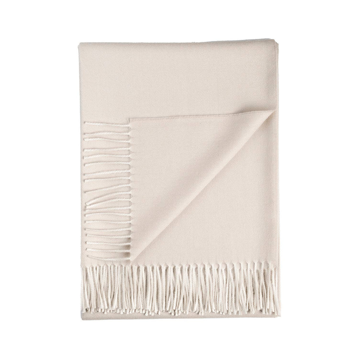 White alpaca blanket with fringes on a white background