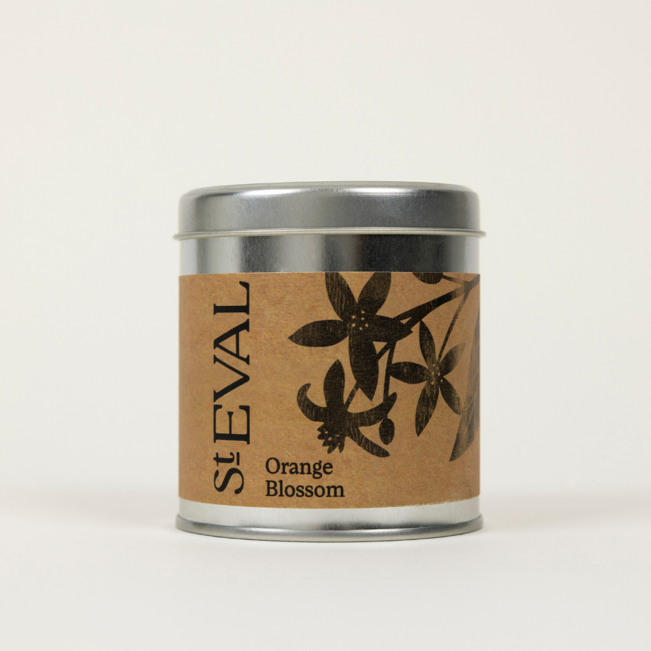 Candle tin labeled 'St. Eval Orange Blossom' on a beige background